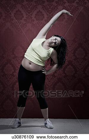 Woman stretching at home View Large Photo Image Stock Photo - Woman stretching at home. Fotosearch