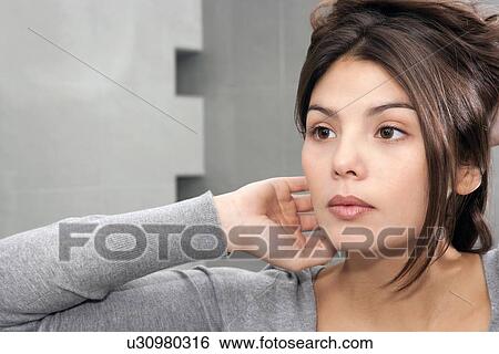 Woman styling her hair in mirror View Large Photo Image Stock Photograph - Woman styling her hair in mirror. Fotosearch