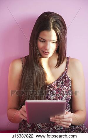 Woman using tablet computer on bed View Large Photo Image Stock Image - Woman using tablet computer on bed. Fotosearch