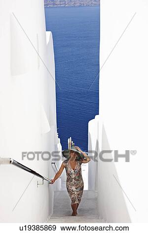 Woman walking up narrow staircase View Large Photo Image Stock Photo - Woman walking up narrow staircase. Fotosearch