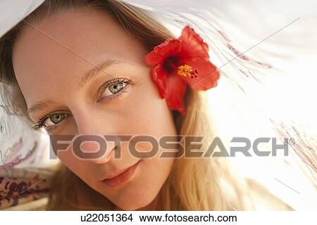 Picture - Woman wearing flower in her hair. Fotosearch