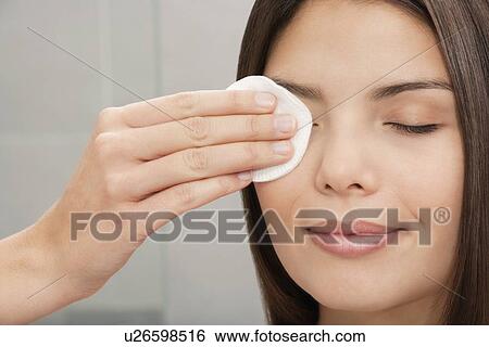 Woman wiping eye with cotton pad View Large Photo Image Stock Photograph - Woman wiping eye with cotton pad. Fotosearch