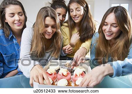 Women eating cupcakes together View Large Photo Image Stock Image - Women eating cupcakes together. Fotosearch