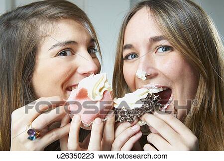 Women eating cupcakes together View Large Photo Image Stock Image - Women eating cupcakes together. Fotosearch