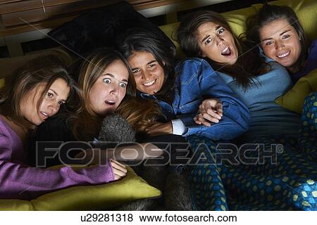 Women watching scary movie together View Large Photo Image Stock Photo - Women watching scary movie together. Fotosearch