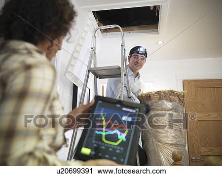 Worker carrying insulation to attic View Large Photo Image Stock Image - Worker carrying insulation to attic. Fotosearch