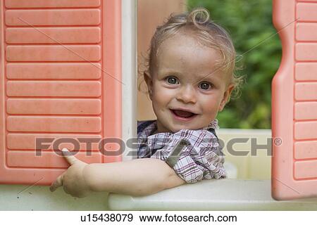 Stock Photo - Baby girl smiling in playhouse. Fotosearch
