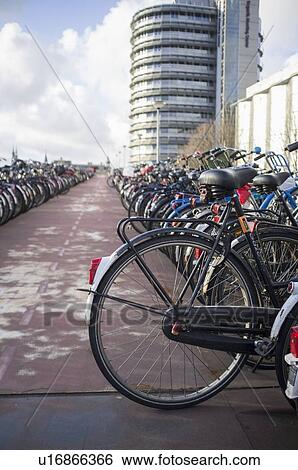 Bicycles parked on city sidewalk View Large Photo Image Stock Photograph - Bicycles parked on city sidewalk. Fotosearch