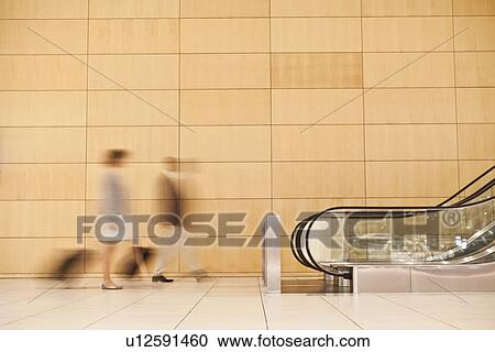 Blurred view of business people in lobby View Large Photo Image Stock Image - Blurred view of business people in lobby. Fotosearch