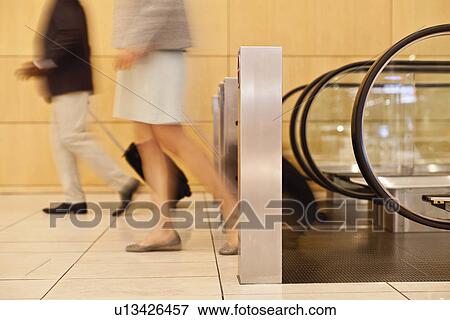 Stock Photo - Blurred view of business people in lobby. Fotosearch