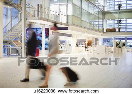 Stock Photo - Blurred view of business people in lobby. Fotosearch