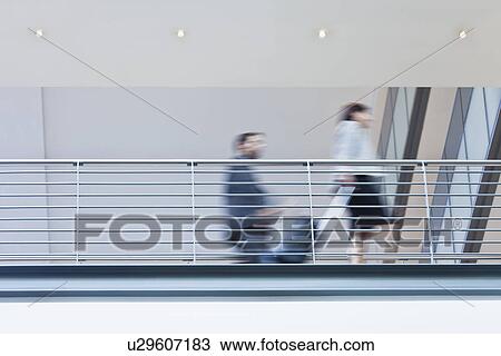 Stock Image - Blurred view of business people. Fotosearch