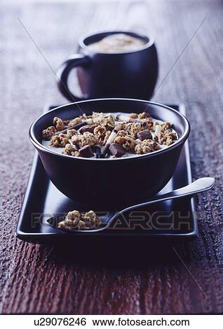 Stock Photograph - Bowl of granola on tray. Fotosearch
