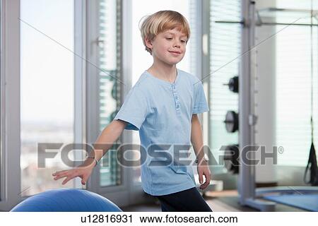 Boy playing with exercise ball in gym View Large Photo Image Stock Image - Boy playing with exercise ball in gym. Fotosearch