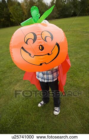 Stock Image - Boy playing with jack oí lantern. Fotosearch