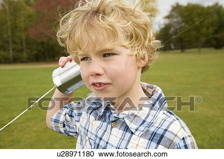 Boy playing with tin can telephone View Large Photo Image Stock Image - Boy playing with tin can telephone. Fotosearch
