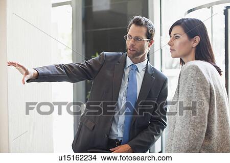 Business man and woman talking View Large Photo Image Picture - Business man and woman talking. Fotosearch