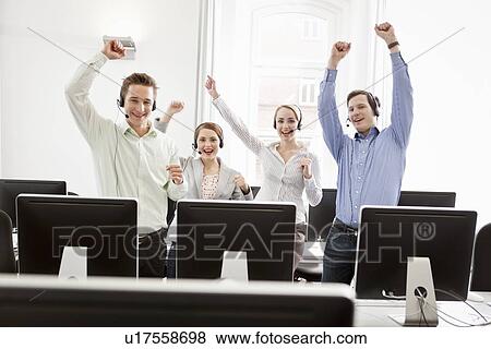 Business people cheering in headsets View Large Photo Image Stock Photo - Business people cheering in headsets. Fotosearch