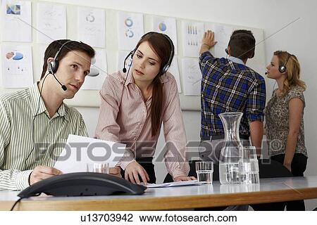 Business people in headsets in office View Large Photo Image Stock Image - Business people in headsets in office. Fotosearch