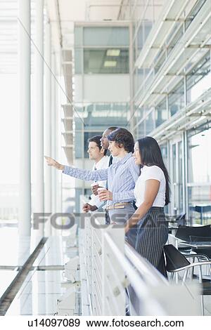 Business people on indoor balcony View Large Photo Image Stock Photo - Business people on indoor balcony. Fotosearch