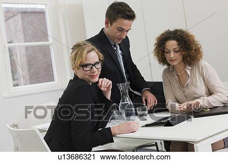 Stock Image - Business people playing board games. Fotosearch