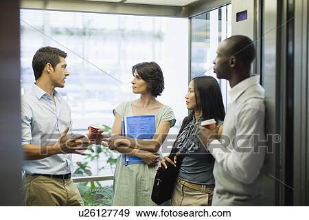 Stock Photo - Business people riding glass elevator. Fotosearch