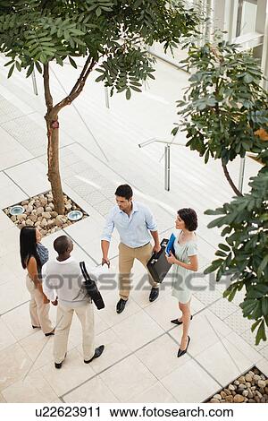 Business people shaking hands in lobby View Large Photo Image Stock Image - Business people shaking hands in lobby. Fotosearch