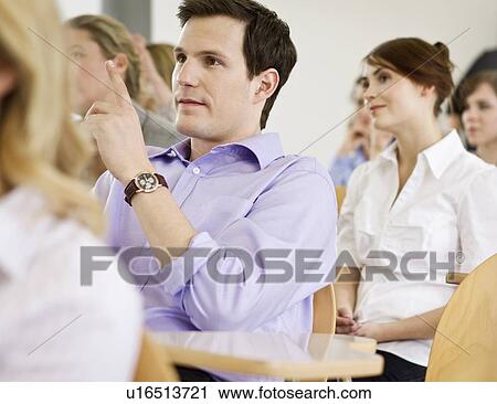 Stock Image - Business people sitting in seminar. Fotosearch