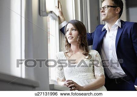 Stock Photograph - Business people standing at window. Fotosearch