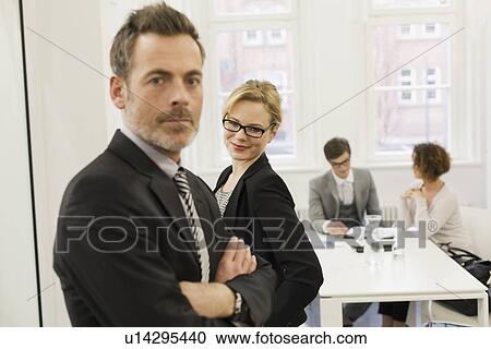 Business people standing in office View Large Photo Image Stock Image - Business people standing in office. Fotosearch