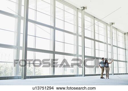 Business people talking in lobby View Large Photo Image Picture - Business people talking in lobby. Fotosearch