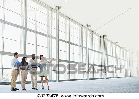 Stock Photo - Business people talking in lobby. Fotosearch