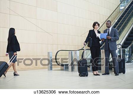 Business people talking in lobby View Large Photo Image Stock Photograph - Business people talking in lobby. Fotosearch