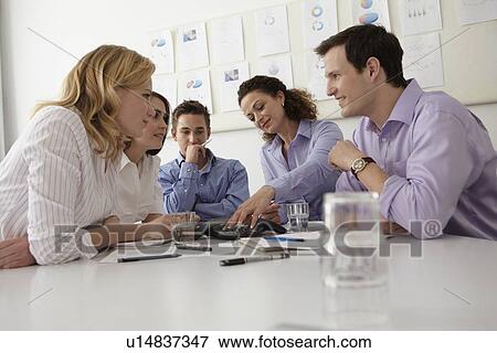 Stock Photo - Business people talking in meeting. Fotosearch