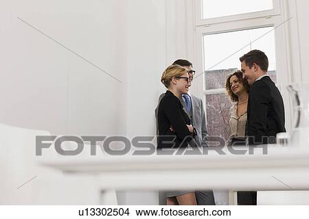 Picture - Business people talking in office. Fotosearch