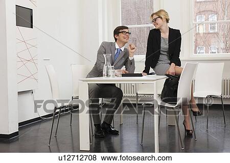 Stock Photo - Business people talking in office. Fotosearch