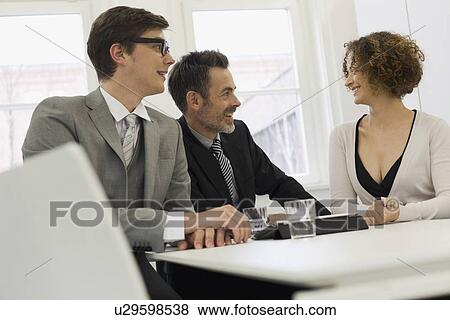 Business people talking in office View Large Photo Image Stock Photo - Business people talking in office. Fotosearch