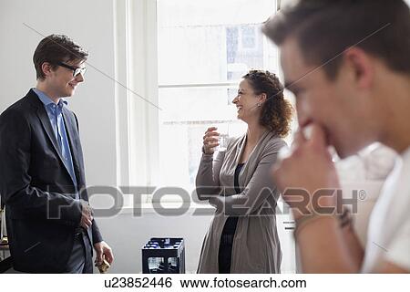 Stock Photograph - Business people talking in office. Fotosearch