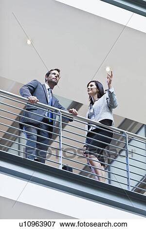 Stock Photo - Business people talking on balcony. Fotosearch