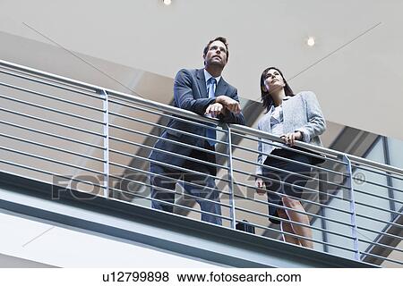 Business people talking on balcony View Large Photo Image Stock Photo - Business people talking on balcony. Fotosearch