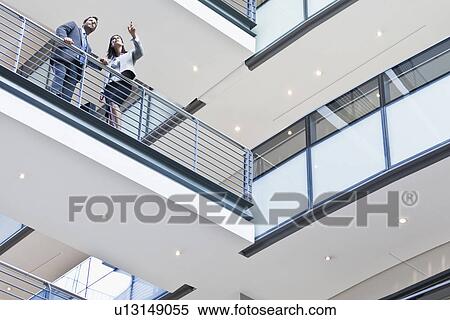 Stock Photography - Business people talking on balcony. Fotosearch