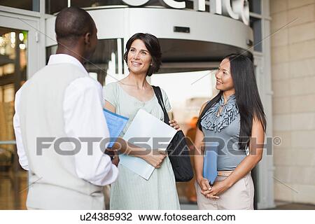 Business people talking outside building View Large Photo Image Stock Image - Business people talking outside building. Fotosearch