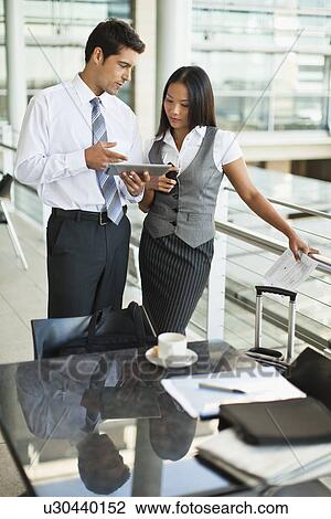 Stock Image - Business people using tablet computer. Fotosearch