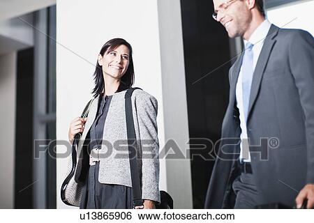 Business people walking in office View Large Photo Image Stock Photograph - Business people walking in office. Fotosearch