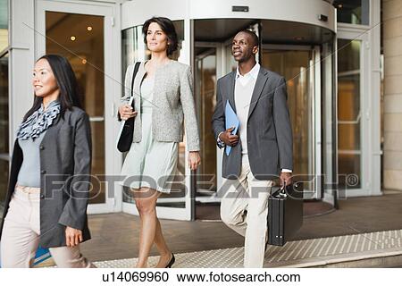 Stock Image - Business people walking on steps. Fotosearch