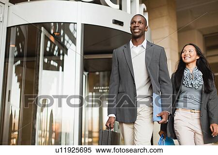 Business people walking outside building View Large Photo Image Stock Photography - Business people walking outside building. Fotosearch