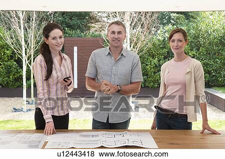 Business people with blueprints View Large Photo Image Stock Photo - Business people with blueprints. Fotosearch