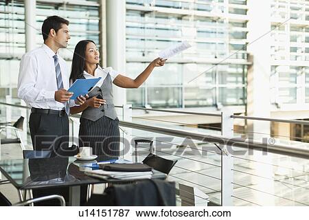 Stock Photo - Business people working in cafe. Fotosearch