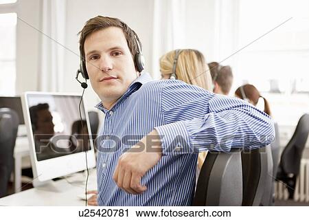 Stock Image - Business people working in headsets. Fotosearch