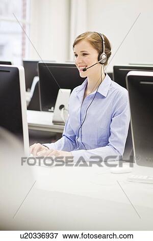 Business people working in headsets View Large Photo Image Stock Photo - Business people working in headsets. Fotosearch